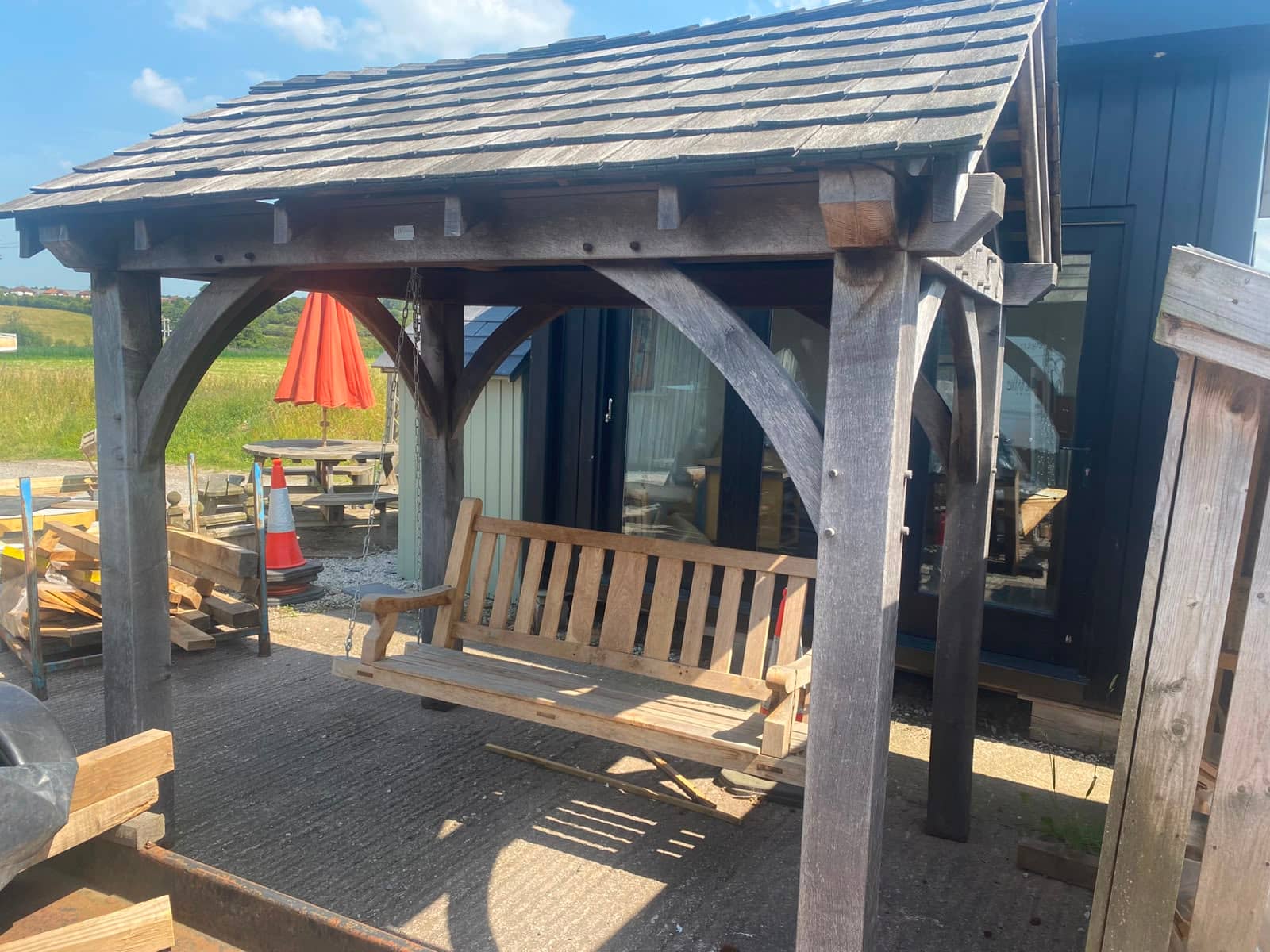 Oak framed gazebo with swing seat and cedar roof, ex-display at Woodstyle Joinery, Carlisle